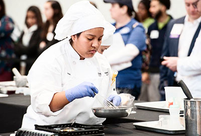 Student cooking at the culinary competition